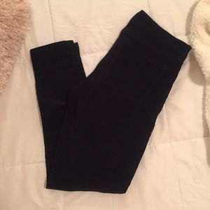 Black skinny corduroys with zip front pockets